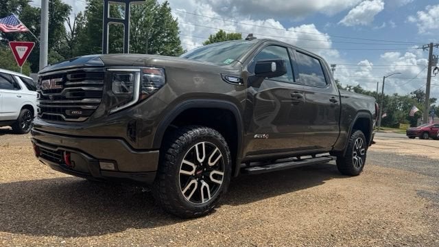 2023 GMC Sierra 1500 AT4 in Deep Bronze Metallic — front three-quarter view